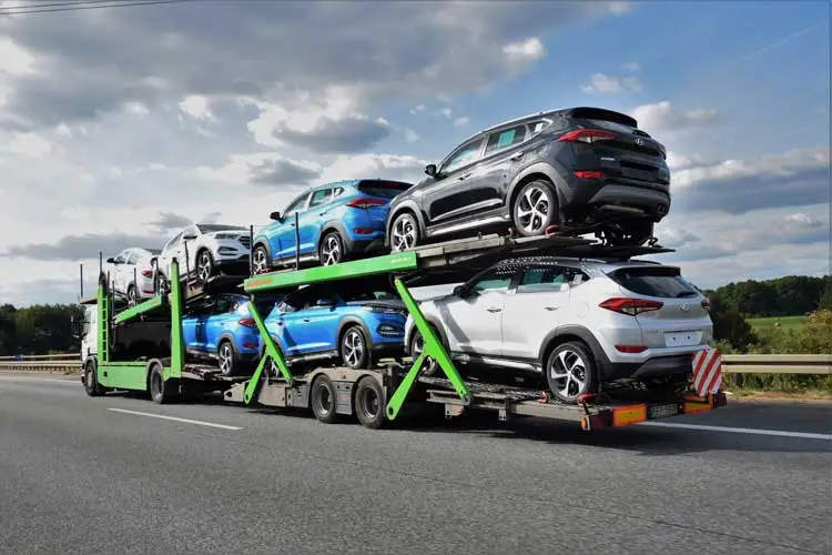 Open car carrier transporting multiple vehicles nationwide